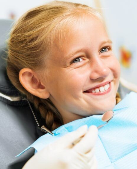 Child sharing healthy smile during children's dentistry visit