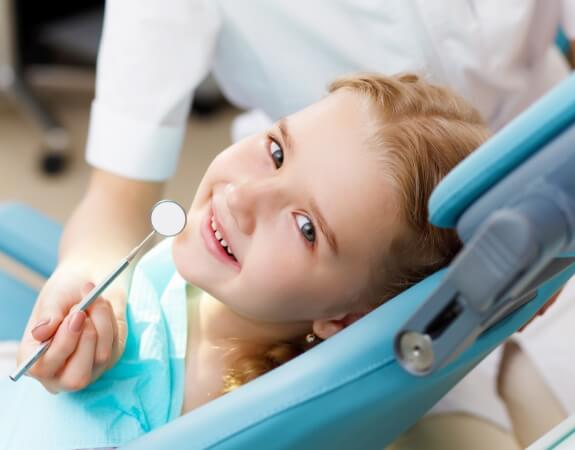 Child smiling after dental sealants