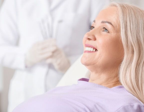 Smiling woman enjoying the benefits of dental implants